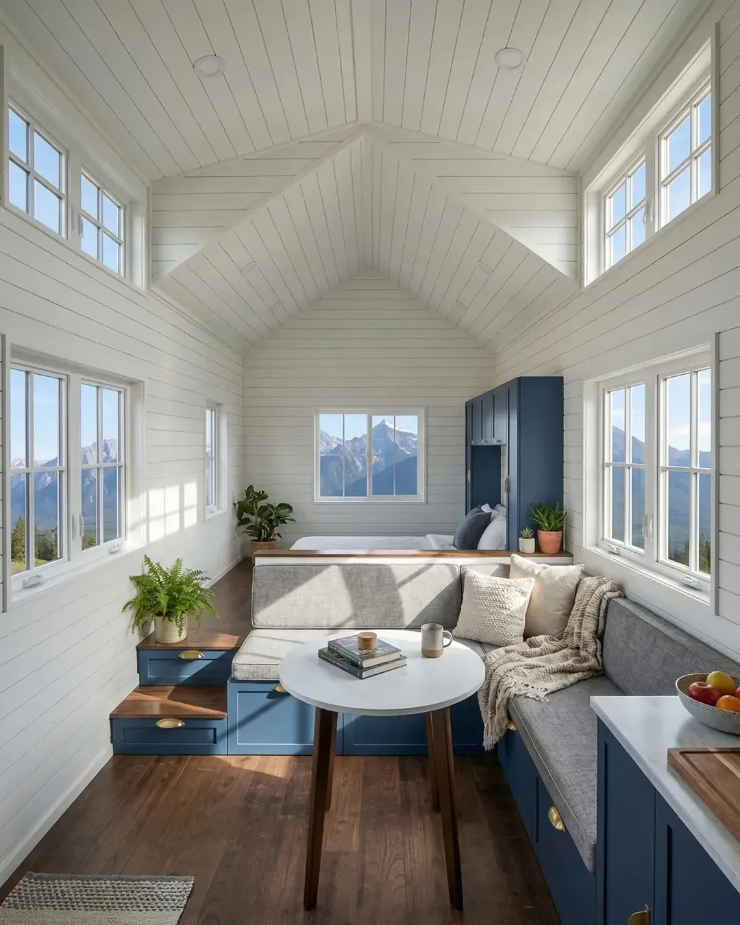 Bright white shiplap tiny home interior with blue cabinetry and mountain views — Waco ADU eligible