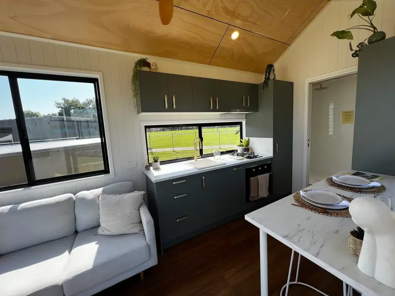 Modern Open Concept Tiny Home Kitchen with Integrated Appliances and Cedar Trim