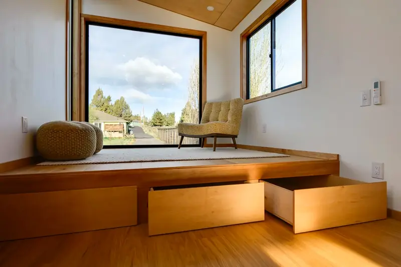 Modern Open Concept Tiny Home Kitchen with Integrated Matte Black Appliances and Teak Trim