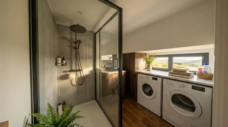 High End Tiny House Walk In Glass Shower and Integrated Laundry Station