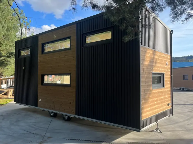 Modern Open Concept Tiny Home Kitchen with Charcoal Cabinets and Walnut Island Trim