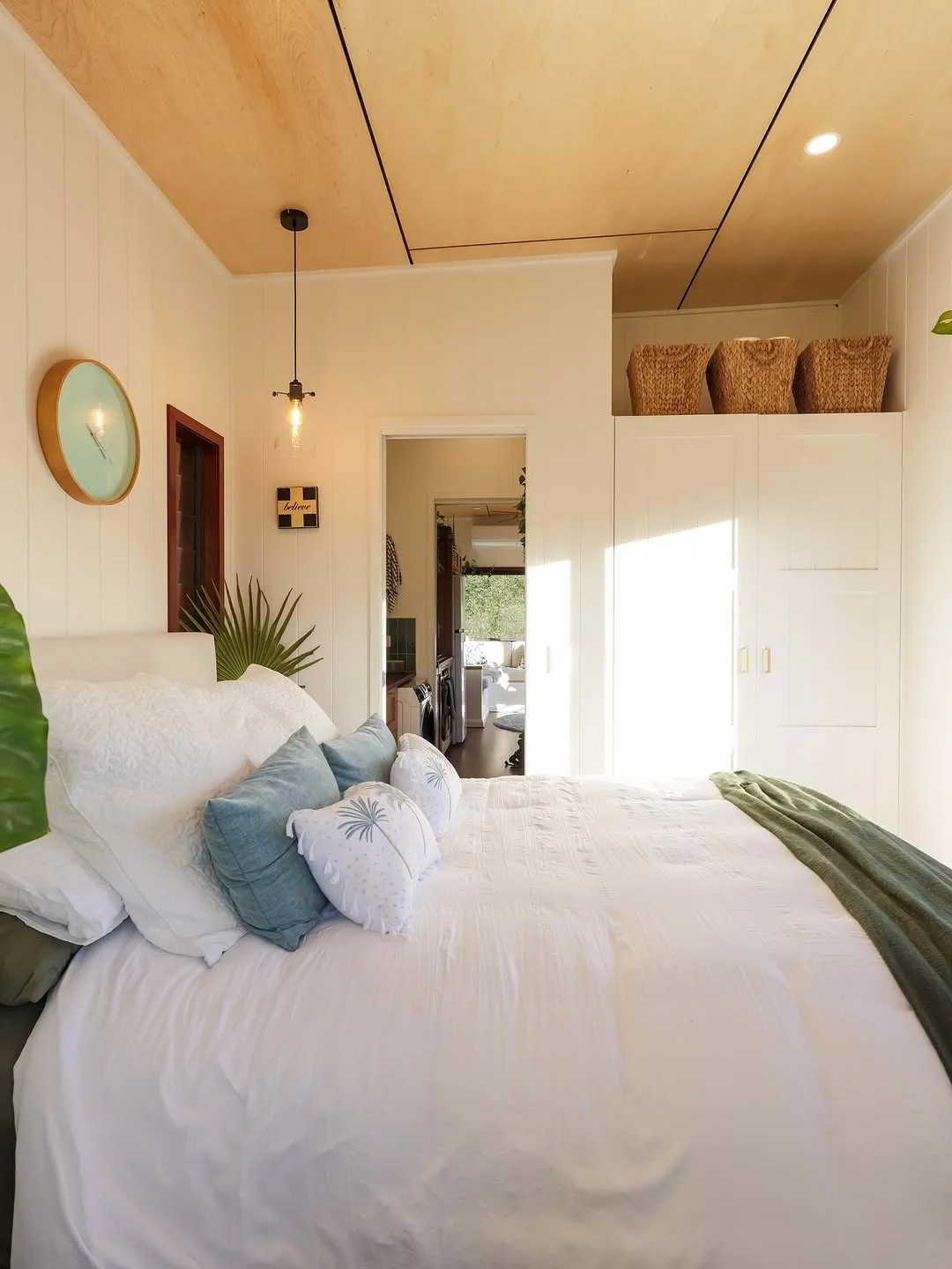 Minimalist Villa Collection Master Bedroom Suite with White Bedding and Plywood Ceiling